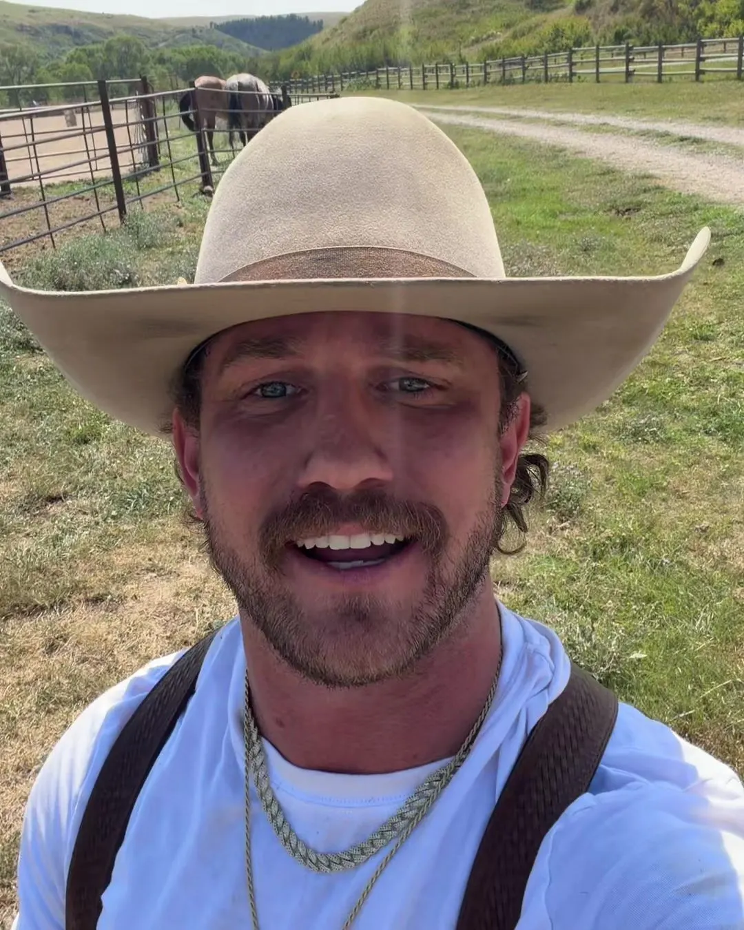 Trevor Brachtenbach in the pasture, in his hat and suspenders